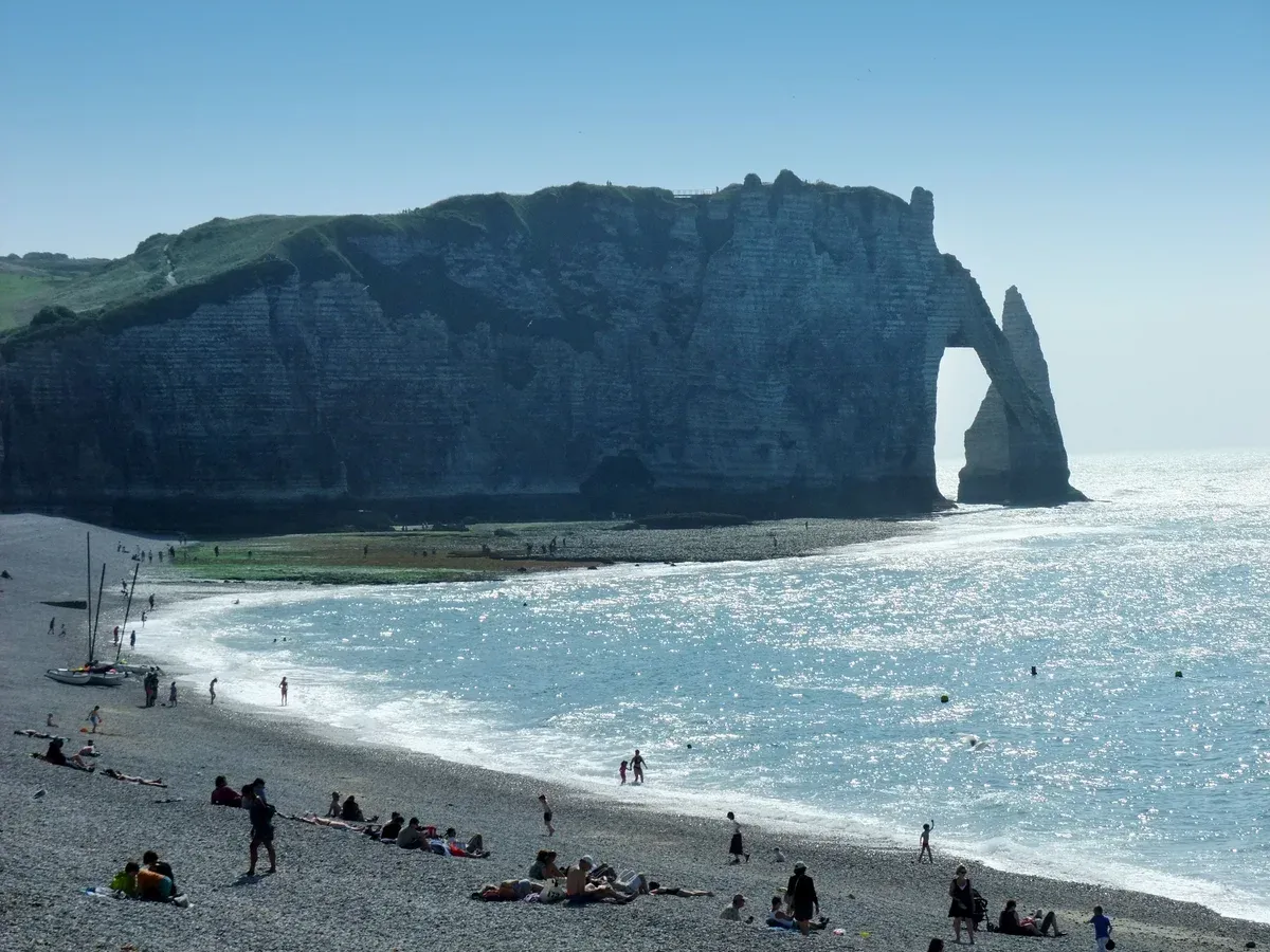 The Porte d'Aval arch and the Aiguille at Étretat, on the coast day of Normandy tours from Paris