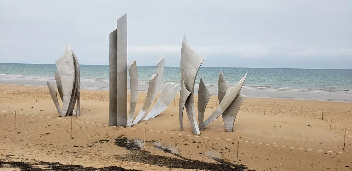 The Les Braves memorial on the sand of Omaha Beach, a stop on most Normandy tours from Paris